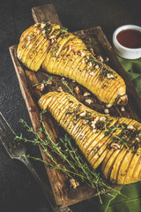 Simple autumn domestic recipes, roasted hasselback butternut squash pumpkin with thyme, honey and maple syrup,