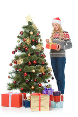 beautiful happy woman putting presents under christmas tree, isolated on white