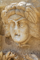 Fototapeta na wymiar Theatrical mask relief, Myra, Demre Turkey
