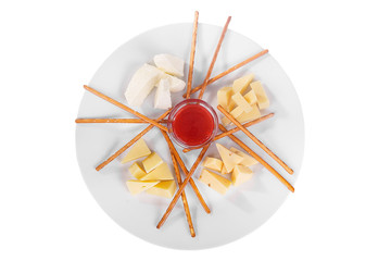 Snack to wine, sweet, a set of cheeses, jam, sweet, salty, cookies, dough sticks aperitif before alcohol, food on plate, white isolated background view from above. For the menu, restaurant, bar, cafe