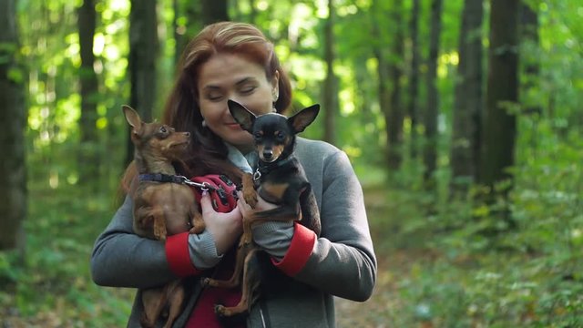 a little dog is trying to lick a woman's face