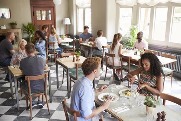 Foto op Plexiglas Customers Enjoying Meals In Busy Restaurant © Monkey Business