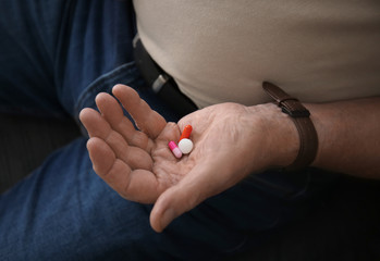 Senior man with pills, closeup