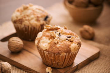 Tasty homemade walnut muffins on table. Sweet pastries