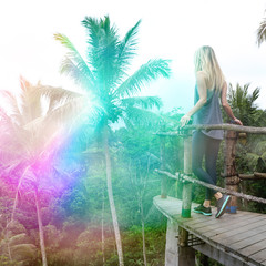 Young s woman enjoying holiday in tropical jungle. Analog photography effects, light leaks, square format. Summer memories concept