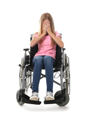 Depressed teenage girl in wheelchair on white background