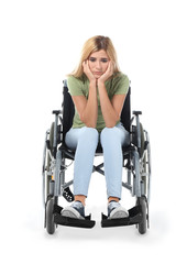 Depressed woman in wheelchair on white background