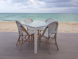 White restaurant bar table and chairs near the beach in Bahamas