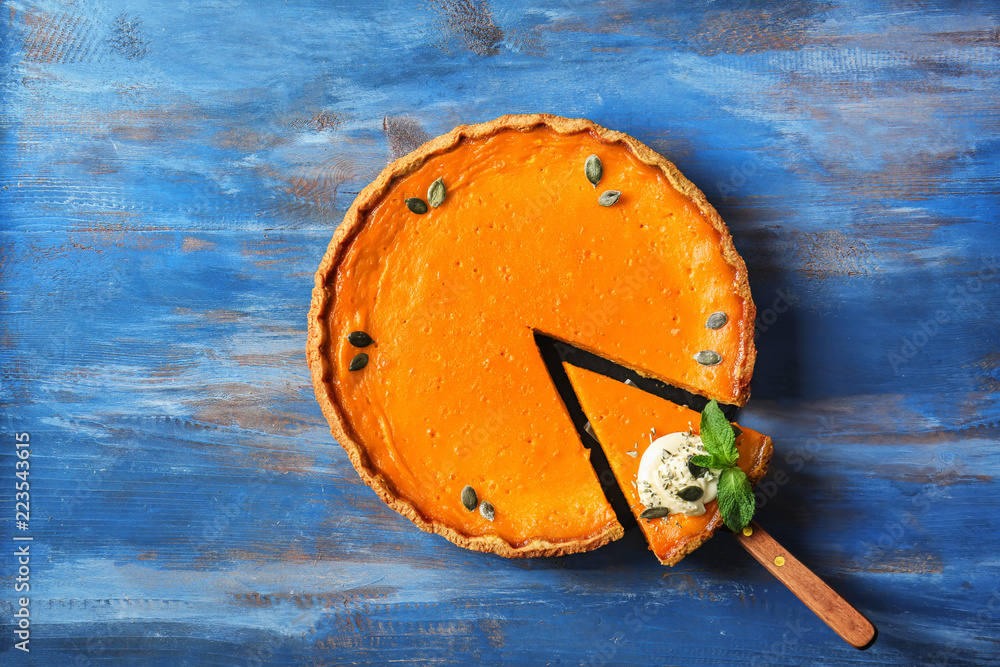 Wall mural tasty pumpkin pie on wooden table, top view