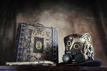 Steampunk,cappello a ingranaggi,valigetta e pistola