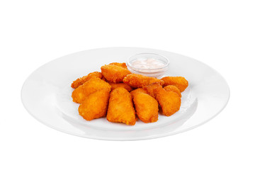 Hot appetizer chicken nuggets in crispy golden breadcrumbs, fried in oil, mayonnaise sauce, tar-tar, before alcohol, on plate, white isolated background Side view. For the menu, restaurant, bar, cafe