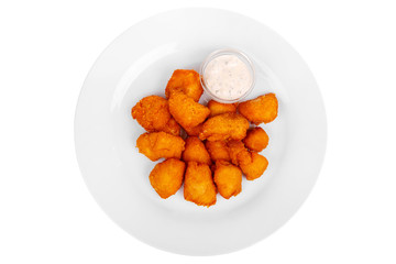 Hot appetizer chicken nuggets in crispy golden breadcrumbs, fried in oil, mayonnaise sauce, tar-tar, before alcohol, on plate, white isolated background view from above. For the menu, restaurant, cafe