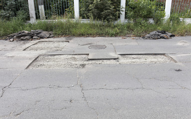 bad asphalt road, repair of asphalt road, pit on the road
