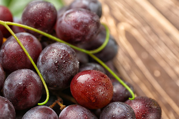 Ripe sweet grapes on wooden table, closeup