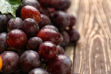 Fototapeta premium Ripe sweet grapes on wooden table, closeup