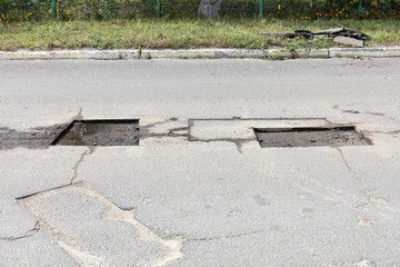bad asphalt road, repair of asphalt road, pit on the road
