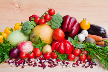 Fresh organic vegetables on a wooden background