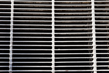 A top and close-up view of a metal grid. Industry and texture as a concept 