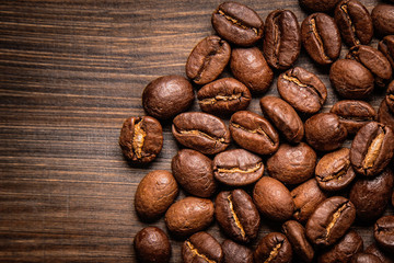 coffee beans on wooden background and empty space
