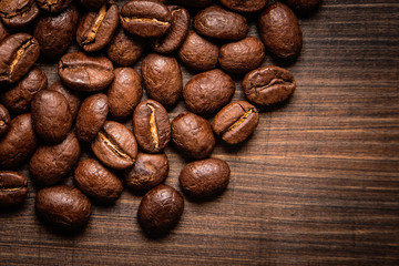 coffee beans on wooden background and empty space