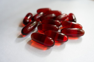 Pile of red capsules of krill oil