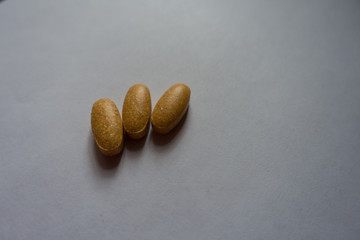 Brown oblong tablets of multivitamins (three items)