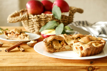 Traditional American Thanks Giving pie, whole & halved apples, cinnamon sticks, anise seeds. Homemade fruit tart baked to golden crust with ingredients. Close up, copy space, top view, background.