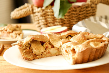 Traditional American Thanks Giving pie, whole & halved apples, cinnamon sticks, anise seeds. Homemade fruit tart baked to golden crust with ingredients. Close up, copy space, top view, background.