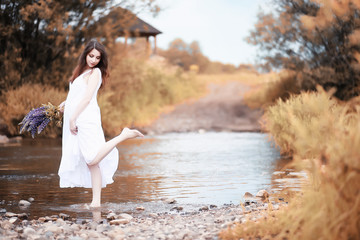Pregnant woman in nature for a walk in the autumn