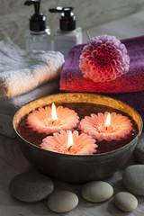 Decorative spa still life with candles, flower and towels, perfect for spa, well-being, beauty and relaxation themes