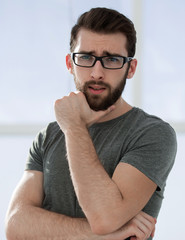 modern young man in a gray t-shirt on a light background