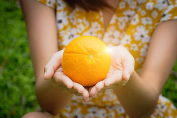 An orange present in girl hands