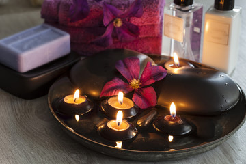 Decorative spa still life with soap, towels, flowers and candles, perfect for spa, well-being, beauty and relaxation themes