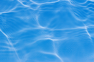 Refractive light distortions in wavy water, on a square shaped grid background