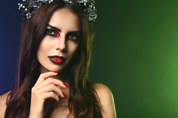 Beautiful woman dressed for Halloween on color background