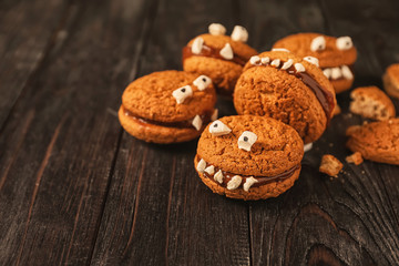 Creative cookies prepared for Halloween party on wooden table