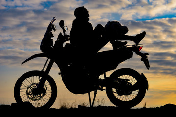 Fototapeta na wymiar traveling alone motorcyclist lady