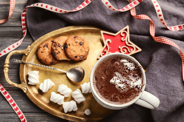 Cup of hot chocolate with marshmallows and cookies on metal tray