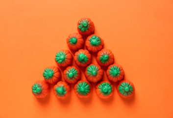 Tasty candies for Halloween party on color background