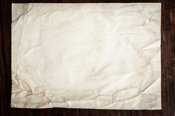 Background texture of crumpled aged paper with spot and stain