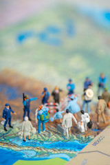 Miniature toy people concept US border patrols against a group of migrant from Mexico