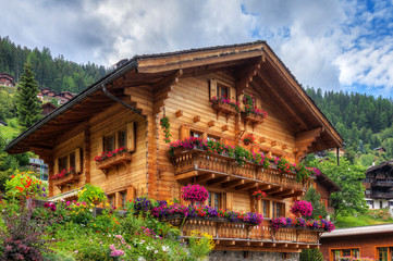 Beautiful traditional wooden house in the alpine village Grimentz, Switzerland, in the canton Valais, municipality Anniviers, with geranium flowers on the balconies
- 223553493