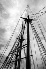 Looking up the masts of a 3-masted schooner on its way under motor from Turku to the Island of Aspö in Archipelago National Park (Skärgårdshavet nationalpark), Finland, in black and white.
