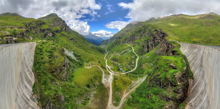 Beautiful panoramic view from the concrete dam of the reservoir lake Lac de Moiry in the alps near Grimentz, Switzerland, on a cloudy summer day