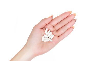 woman hand with white pills isolated on white background