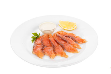 Cold appetizer before alcohol, salmon fillet salted with sauce wasabi, 6 pieces, mayonnaise, sour cream, lemon slice and parsley branch on plate, white isolated background Side view. For the menu