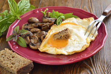 Fried egg with mushrooms for breakfast