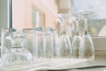 Inverted clean washed glasses on the kitchen towel