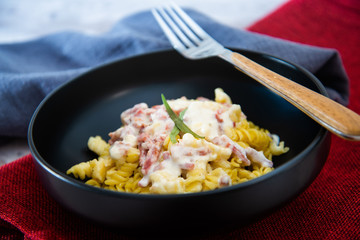 tasty pasta with roast ham on the table