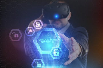 The concept of business, technology, the Internet and the network. A young entrepreneur working on a virtual screen of the future and sees the inscription: Unlock your potential